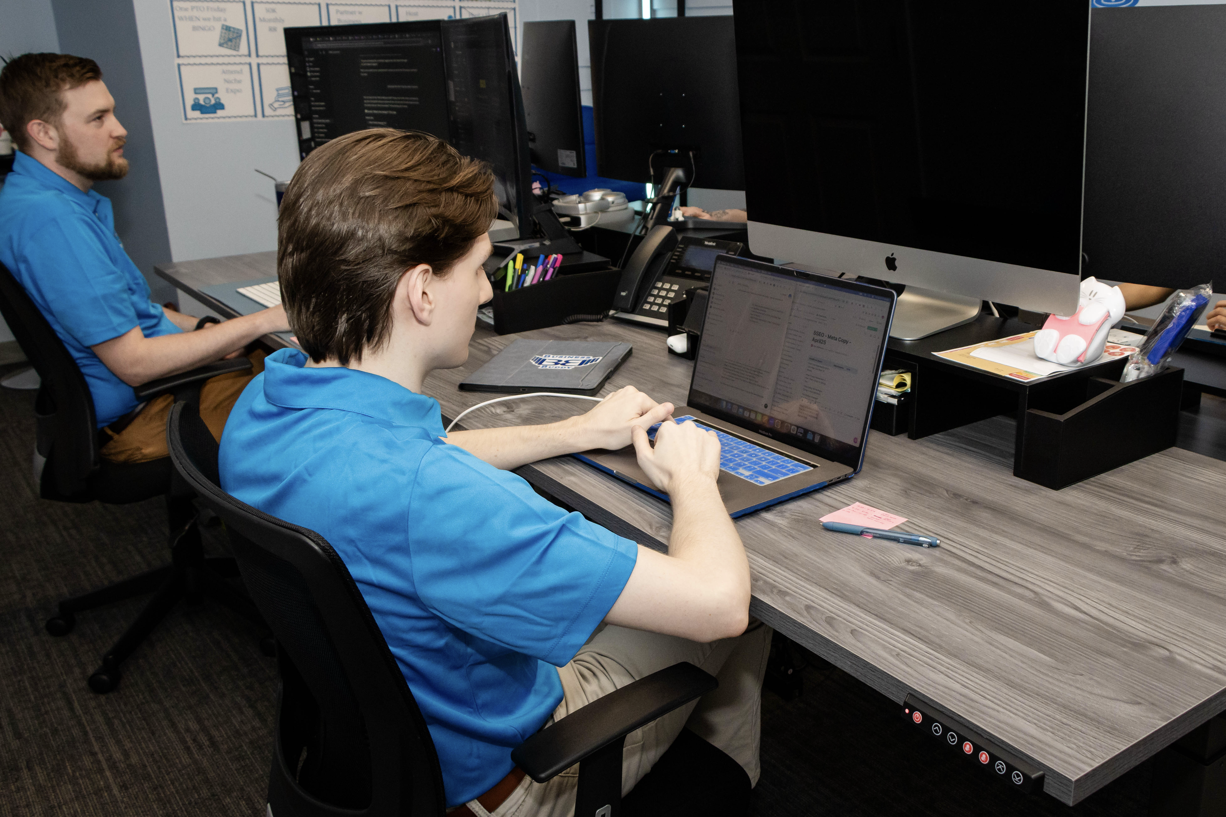 Marketing team outlining rebranding strategy to keep ads running during transition